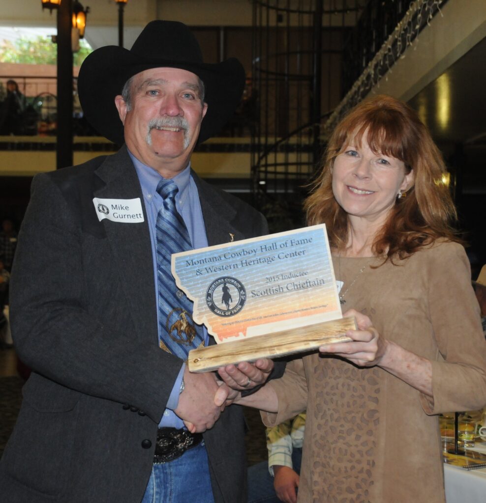 A man and woman holding a certificate.